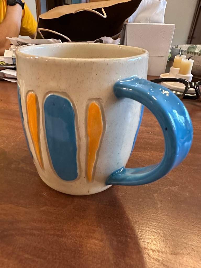 The blue and yellow mug from the handle side