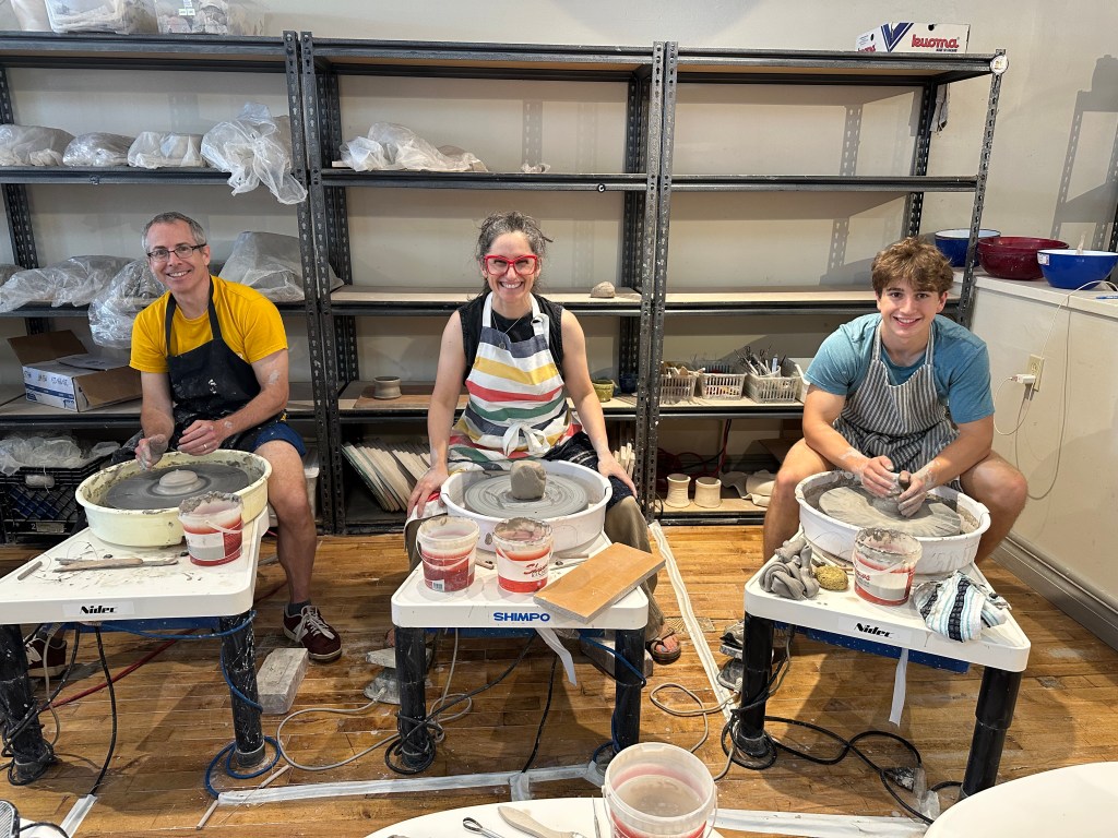 Ed and Max trying the pottery wheel with Robyn